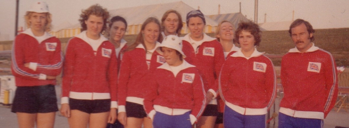 women in 1975 GB tracksuits with male coach