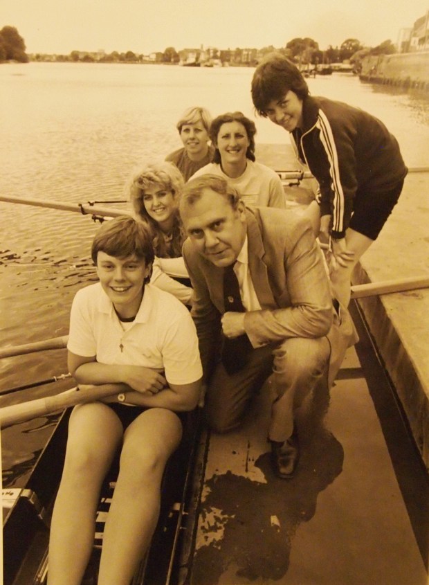 Five women and a man on a landing stage