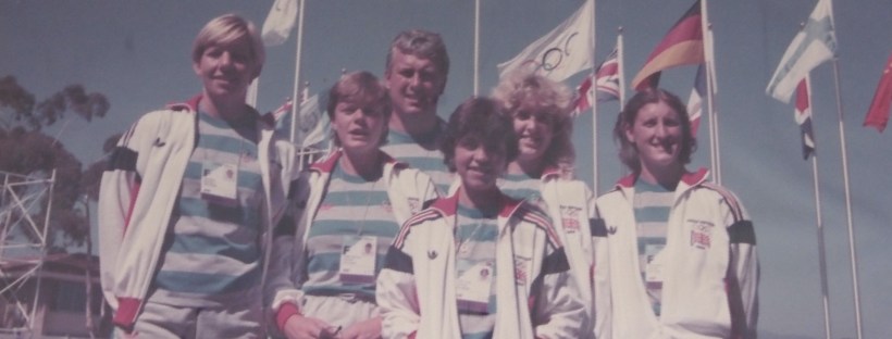 Crew and coach with flags behind
