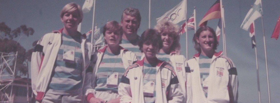 Crew and coach with flags behind