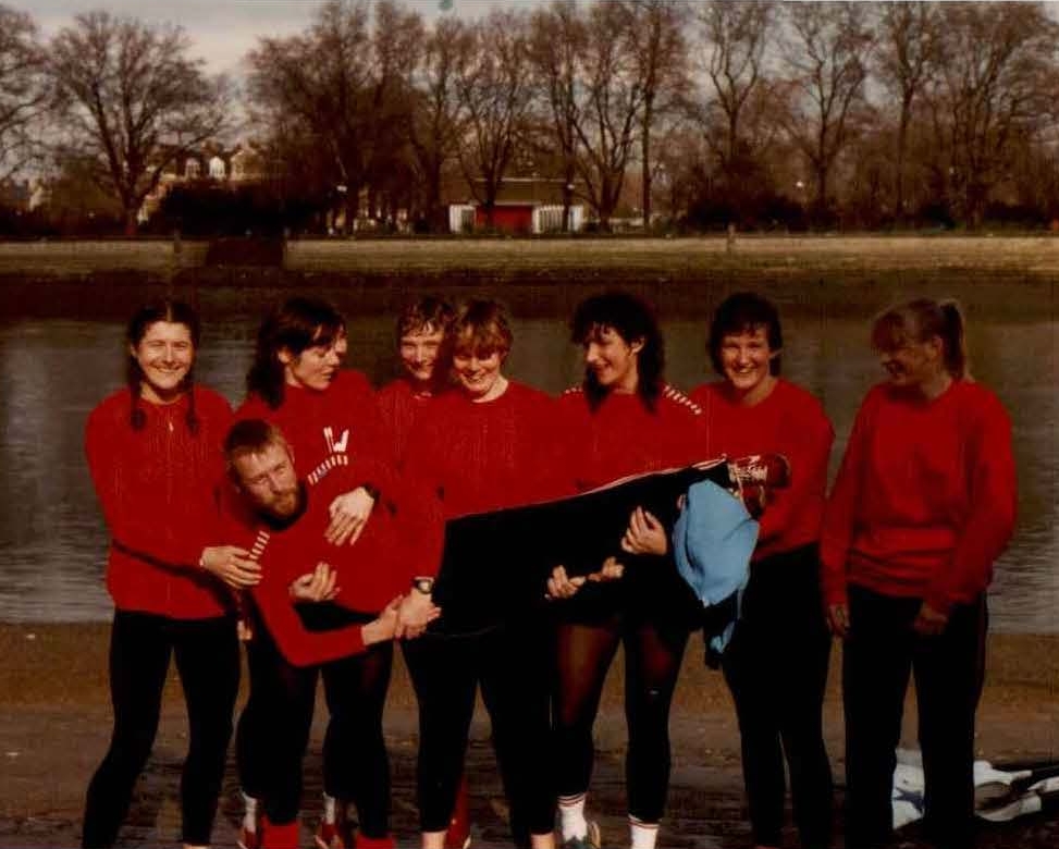 Eight women in red tops holding cox