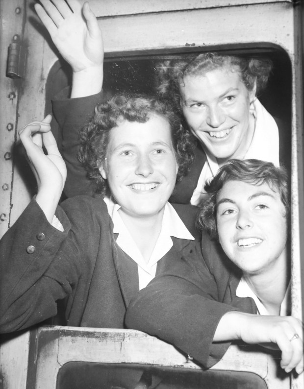 3 women waving from train window