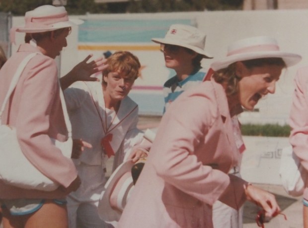 Women in opening ceremony outfits messing about