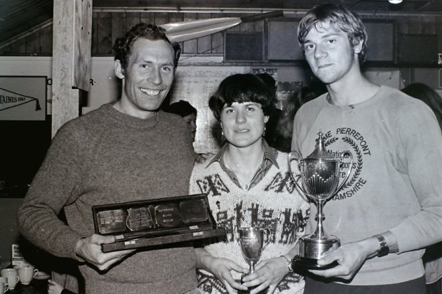 3 rowers holding trophies