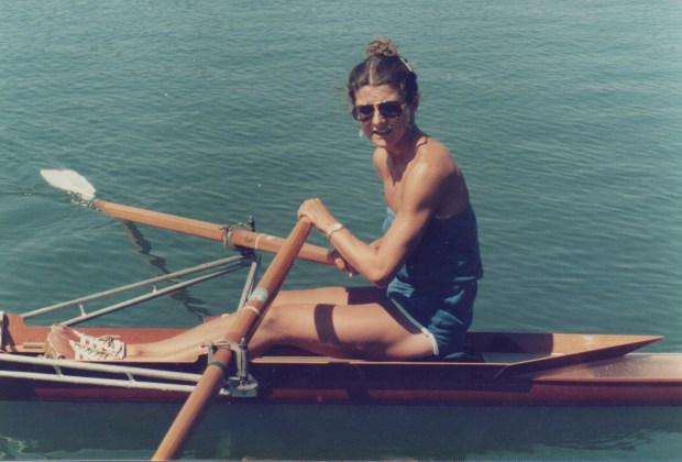 Woman in sculling boat in sunshine