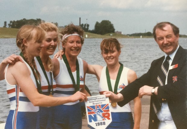 Four women with medals and pennant