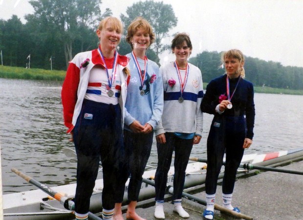 four women on raft with medals in assorted kit