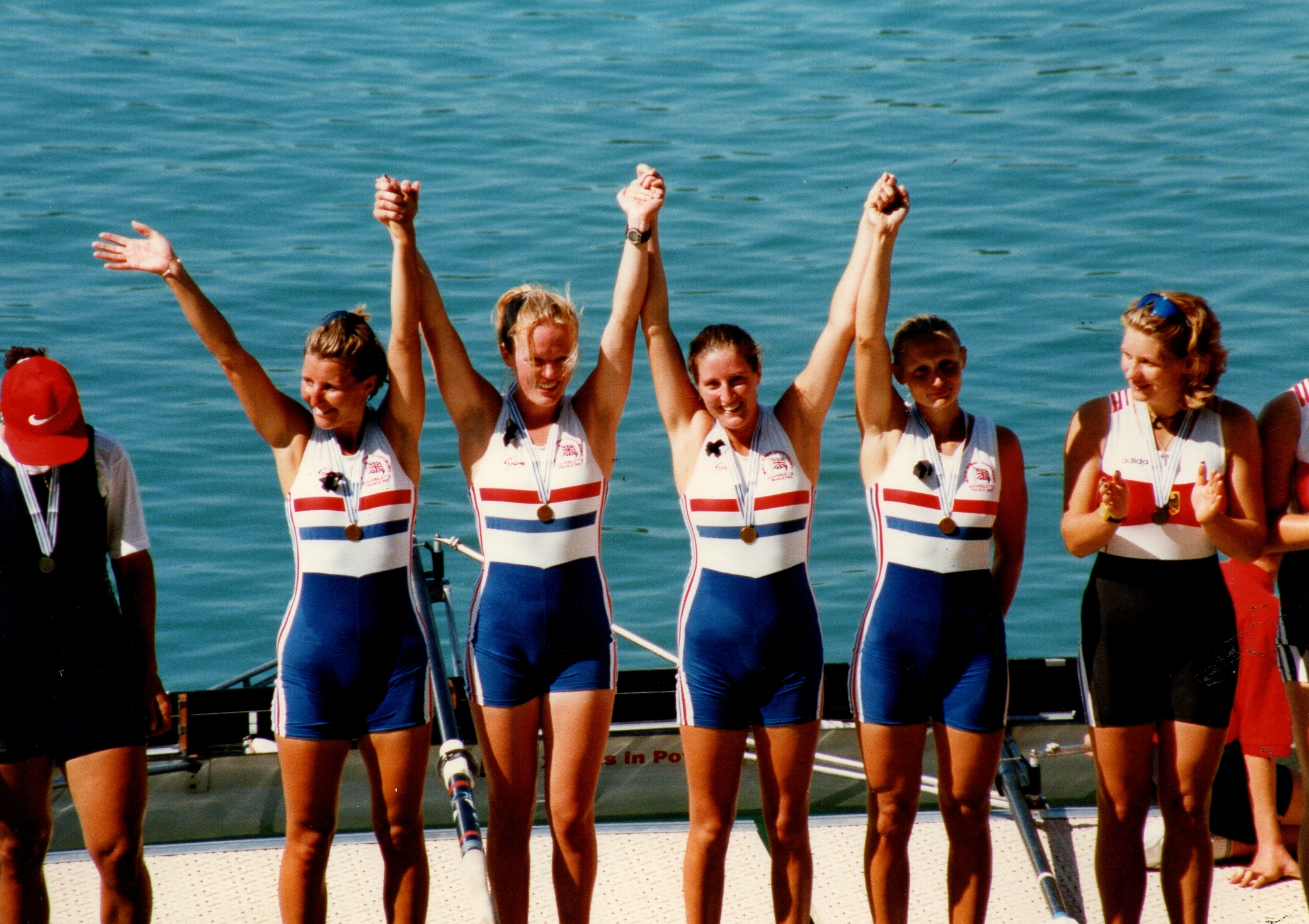 4 women with arms raised