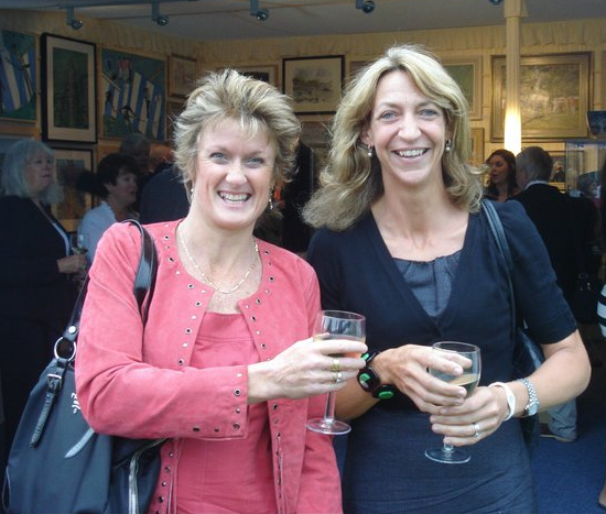 two women in art gallery tent