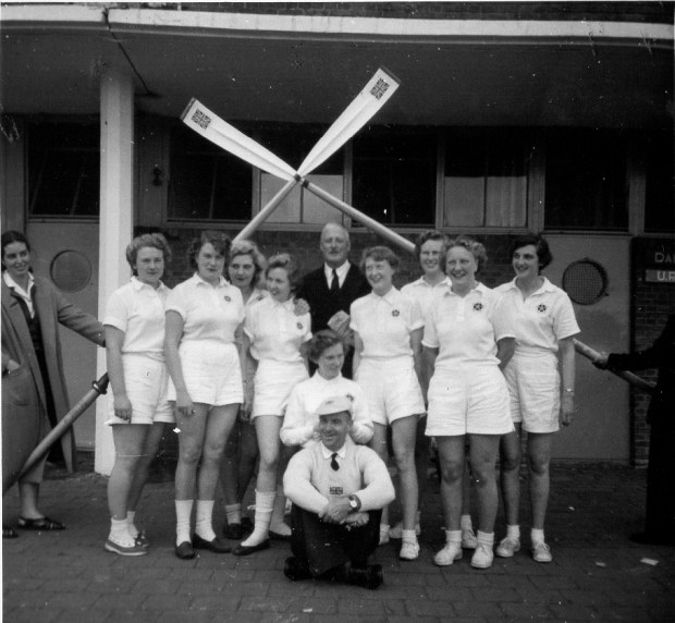 9 Women with crossed blades and 2 male coahes