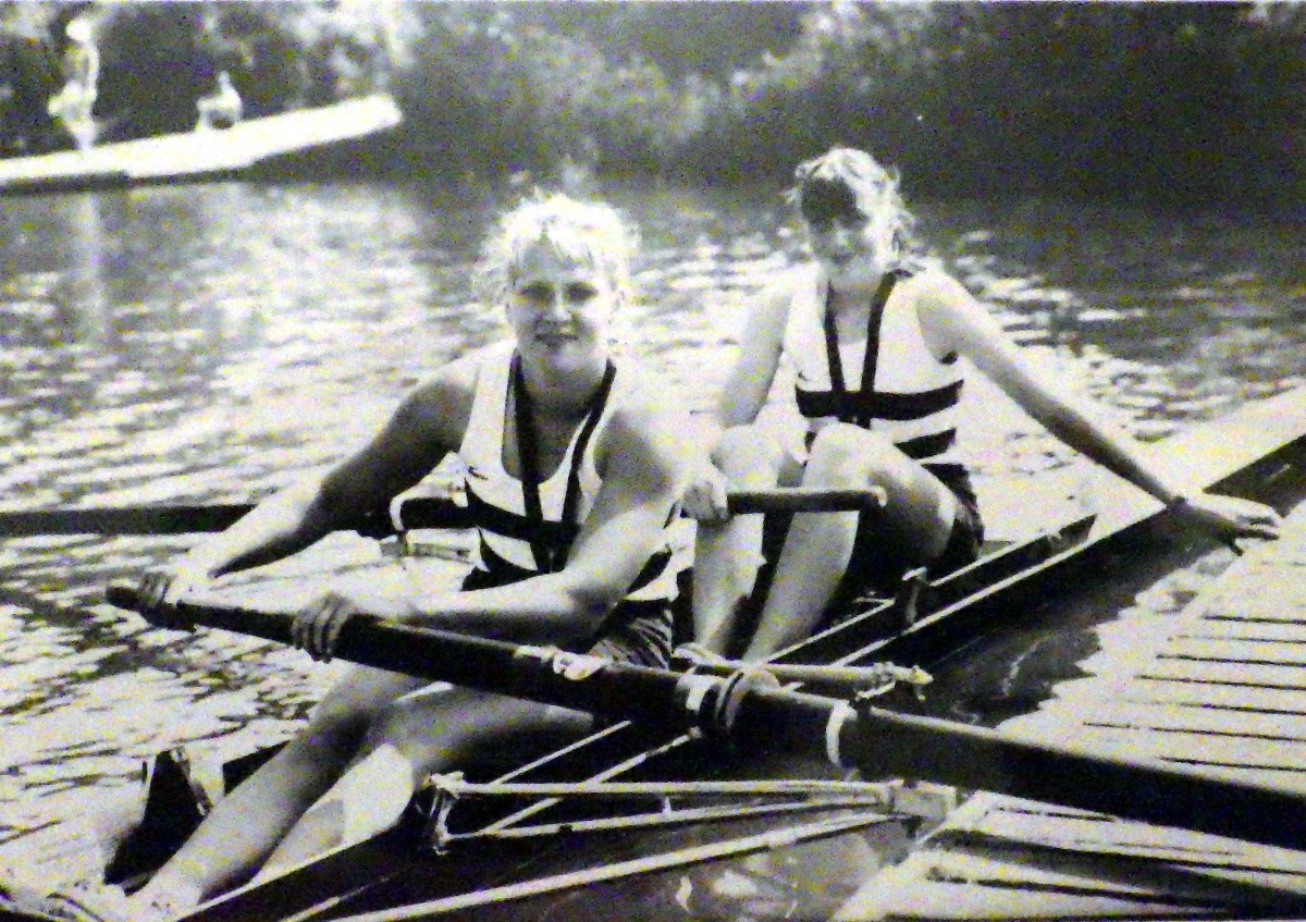 bw photo of two women in pair with medals