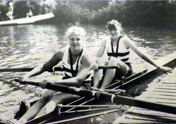 bw photo of two women in pair with medals