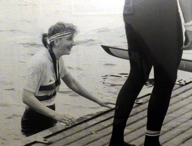 wet woman up to her waist in water by landing stage