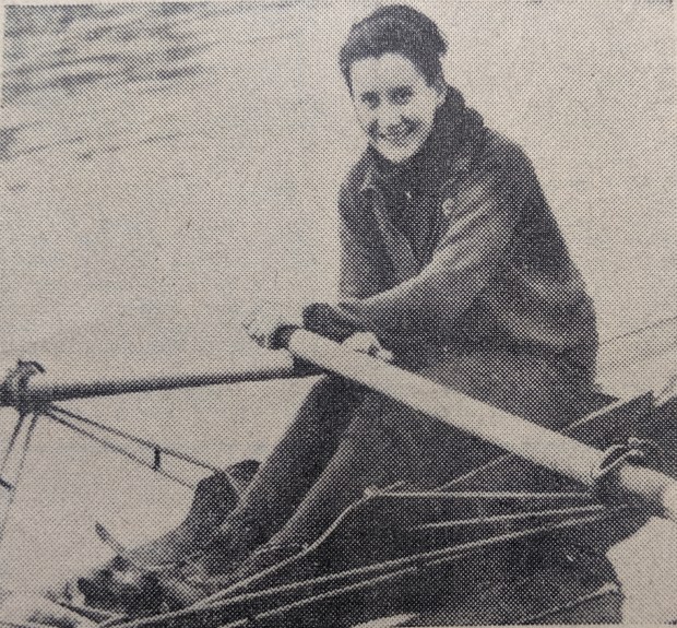 b/w photo of woman smiling in sculling boat