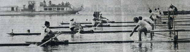 Black and white photo of 4 women starting sculling race