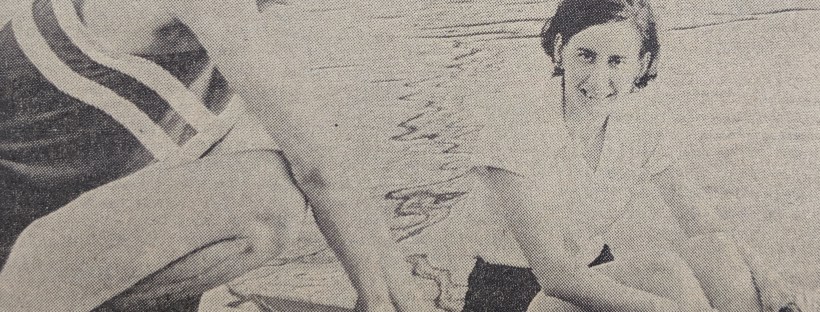 b/w photo of woman in scull on landing stage