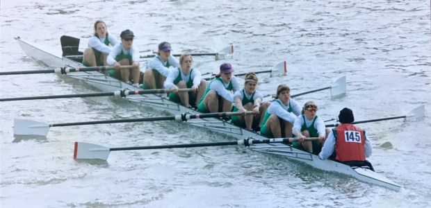 Women's eight in green lycra number 145 on cox