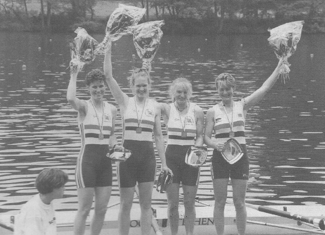 4 women with bouquets and medals