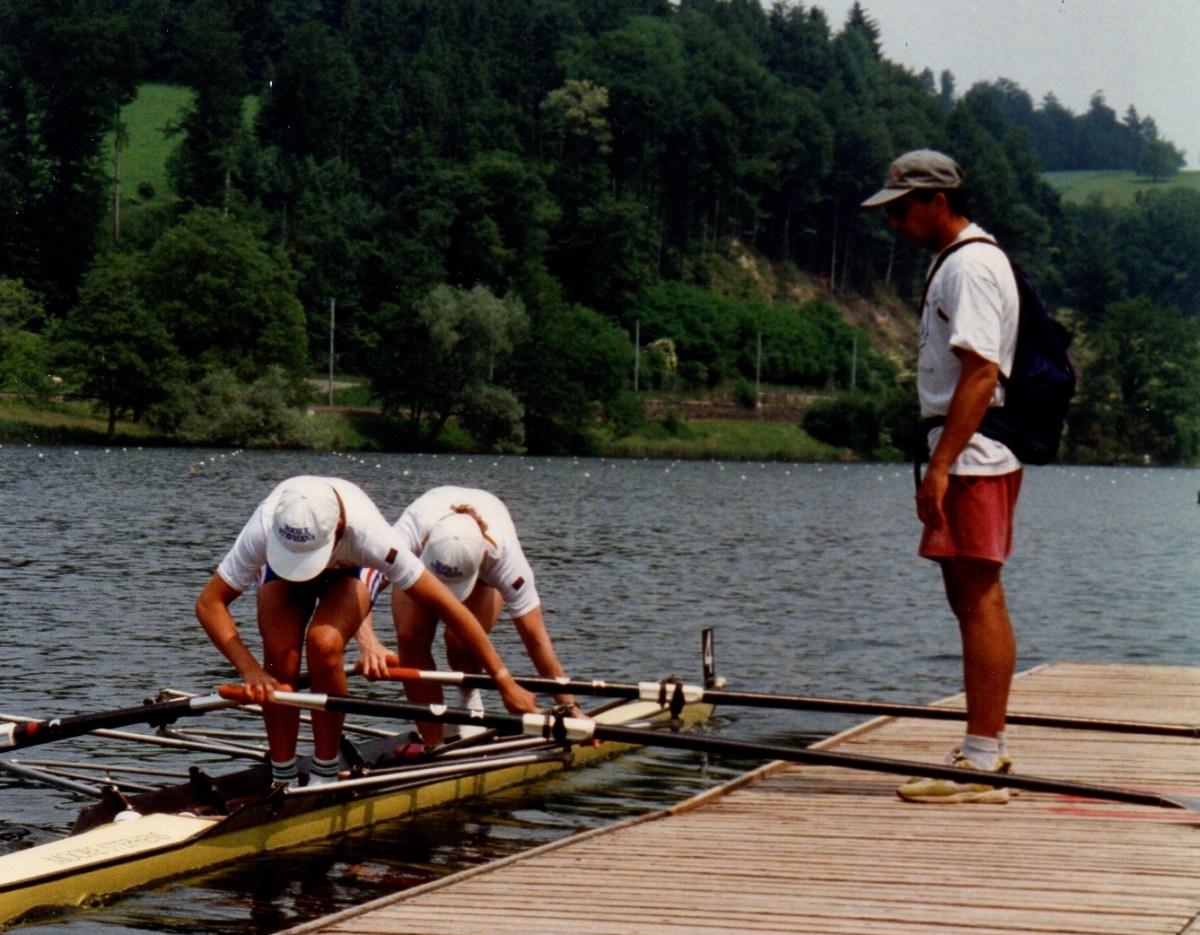 2 women getting into a double scull