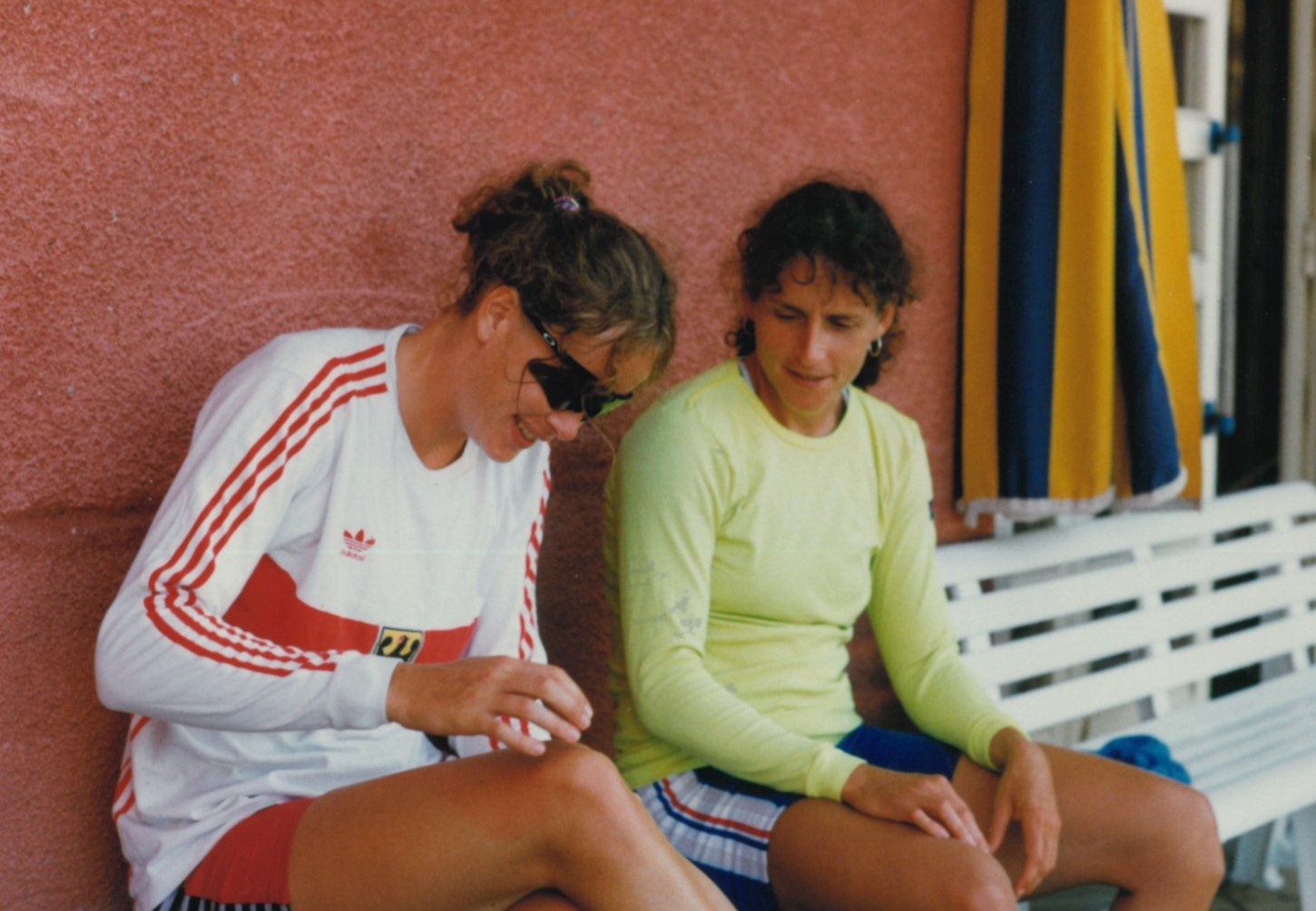 2 women relaxing on bench