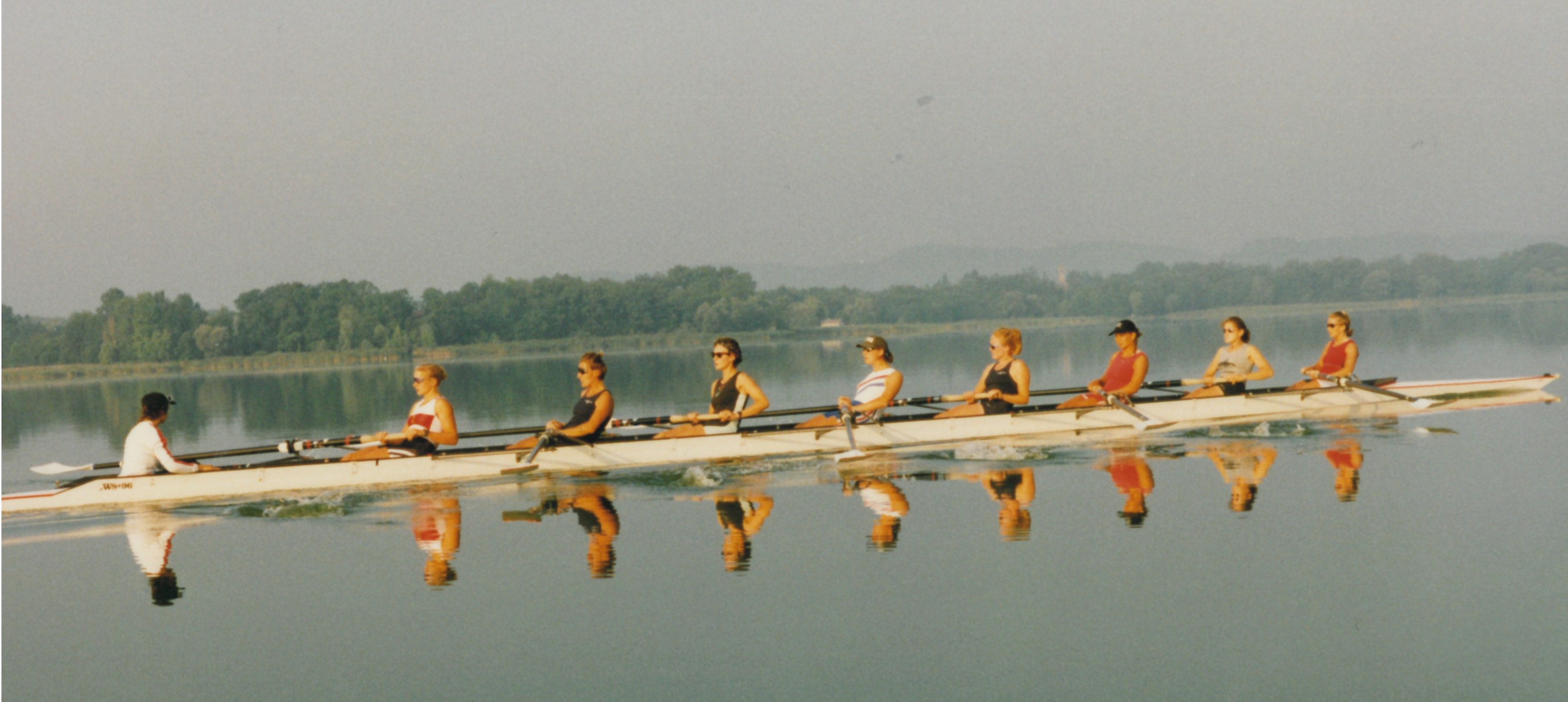 women' eight on mirror-flat water