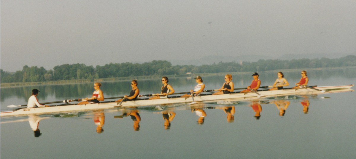 women' eight on mirror-flat water