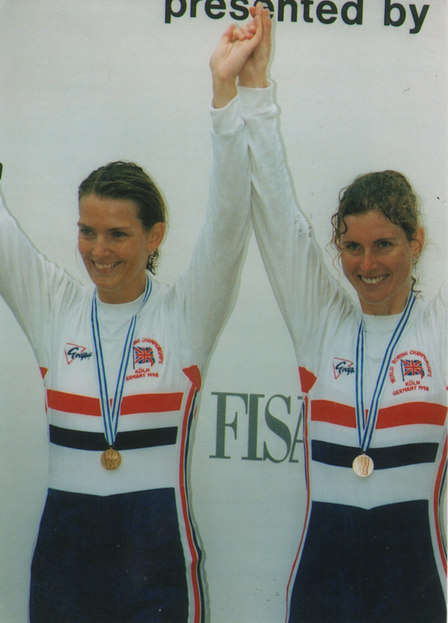 Two women with arms aloft