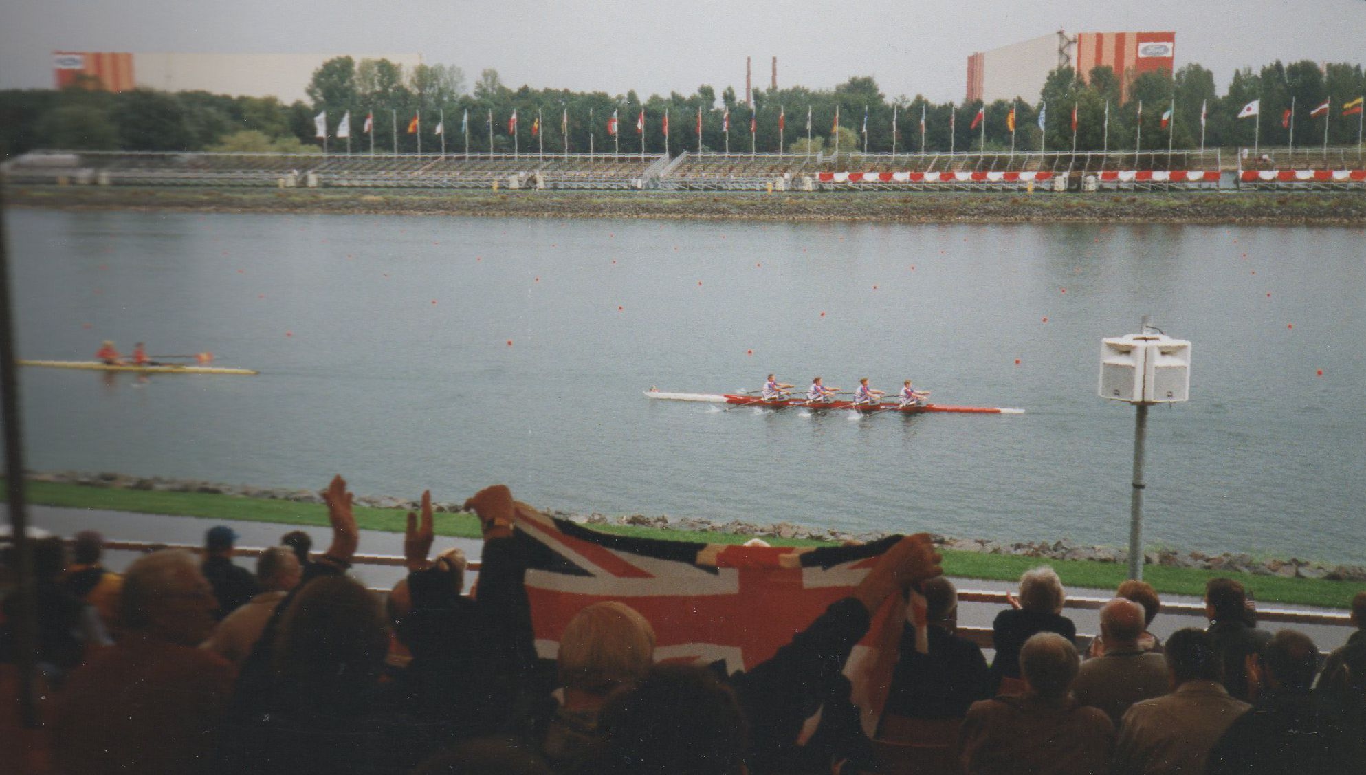 Quad on course with crowd in grandstand in foreground