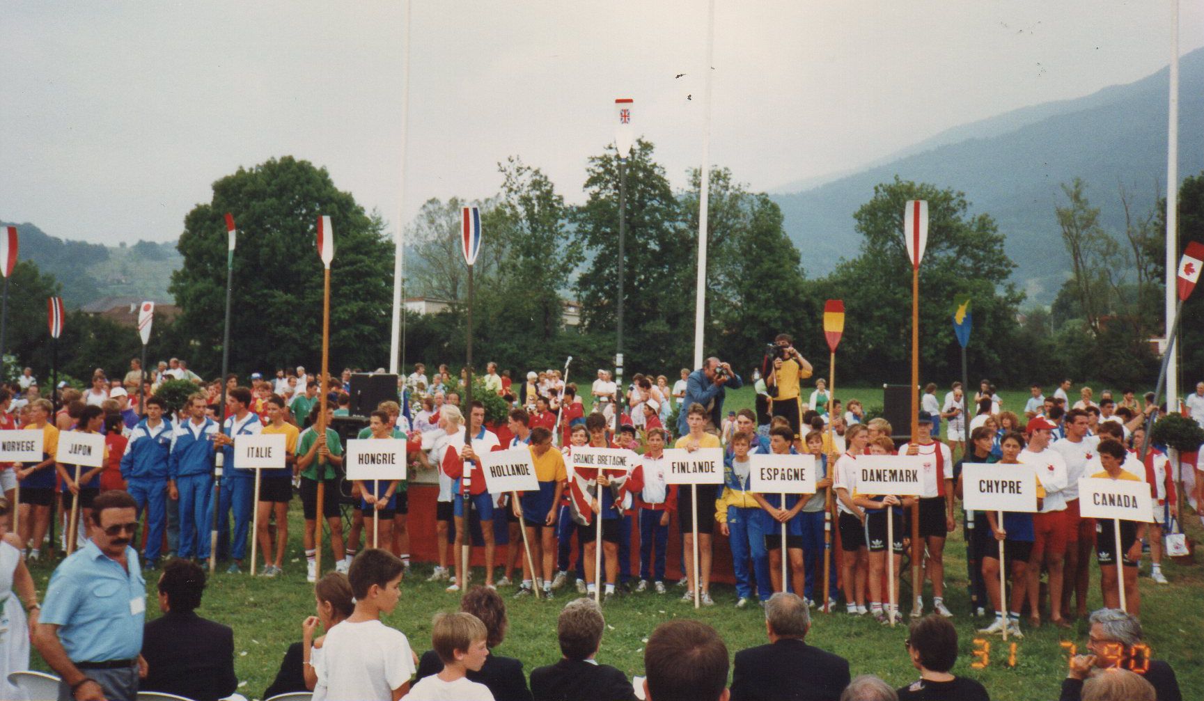 Young rowers lining up with country placards