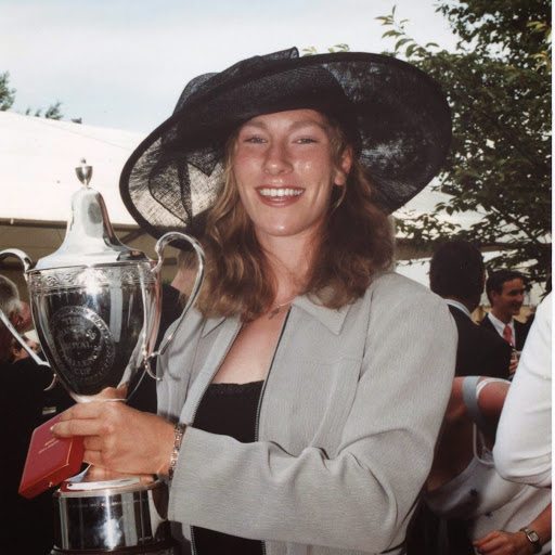 Woman in large hat with silver cup