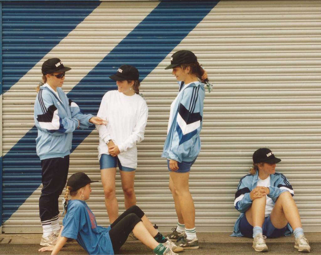 4 women in pale blue tracksuit tops