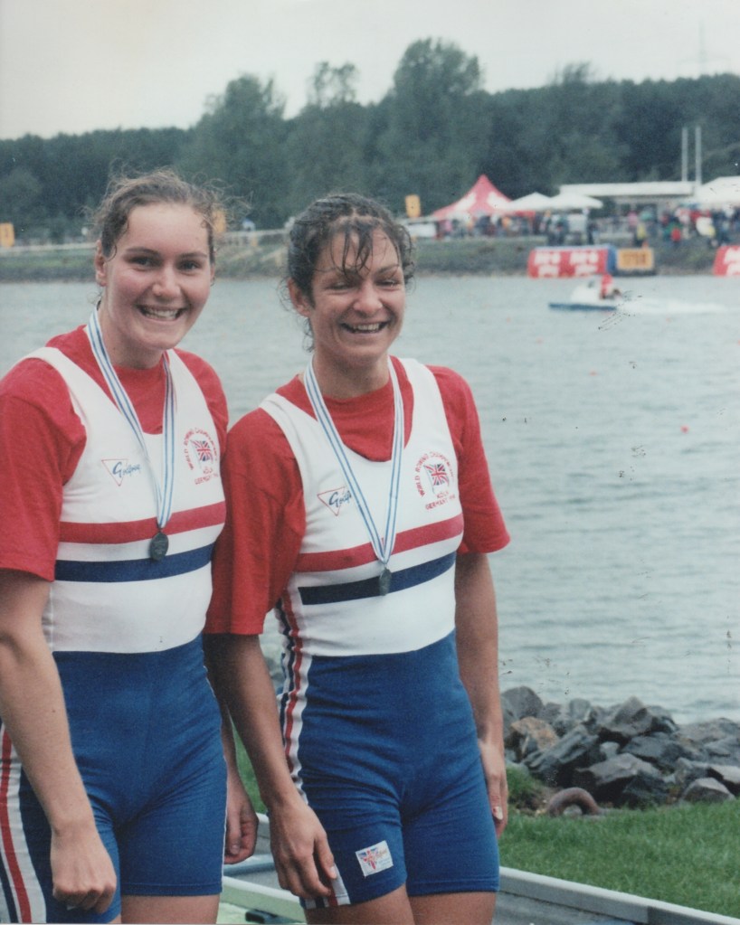 Two women wearing silver medals