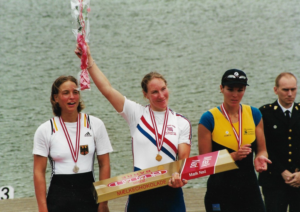 Woman in GBR kit holding bouquet and wearing gold medal