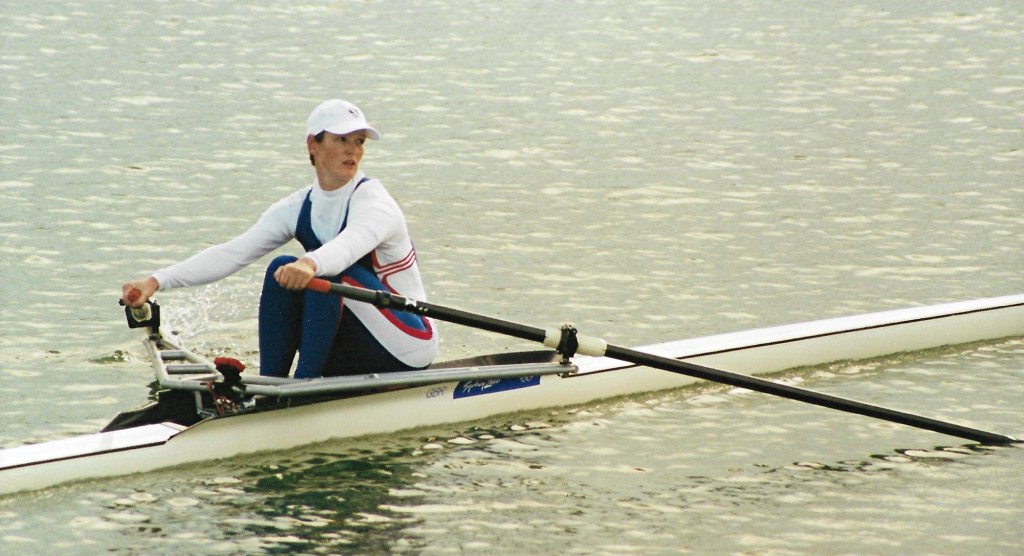 Woman single sculler in leggings