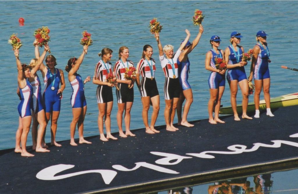 12 women with medals on presentation raft