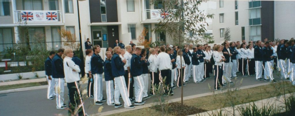 Group of athletes in blue and white tracksuits with reflective stripes on trousers