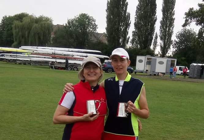 Two women with pots at a regatta