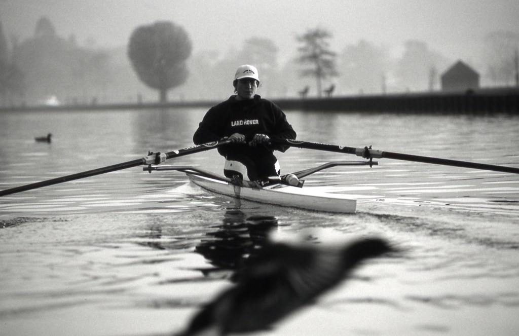woman sculling with Land Rover on her top