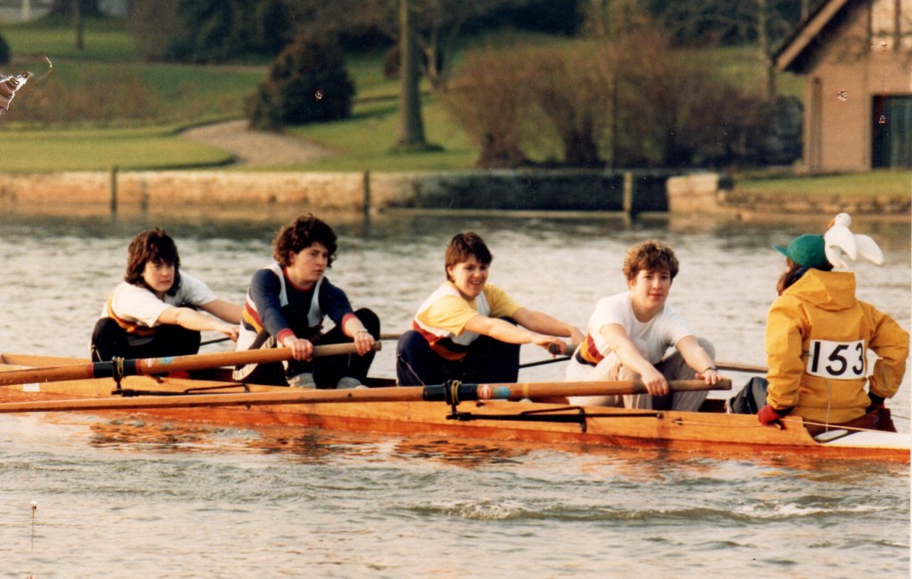 Women's four racing in wooden boat