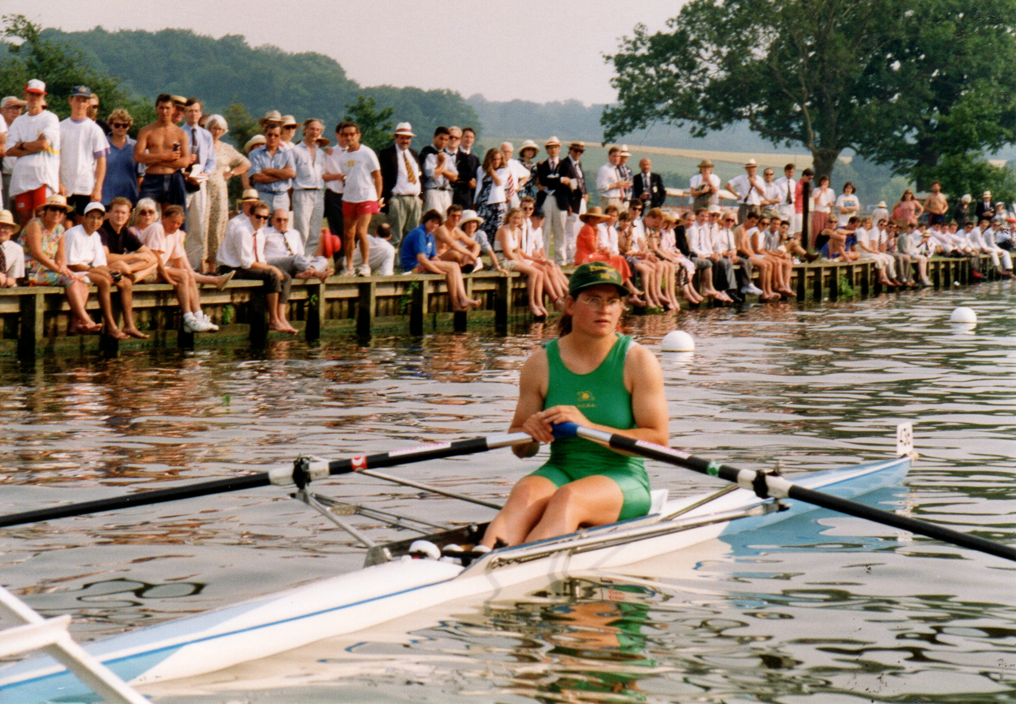 Woman sculler in green lycra at start