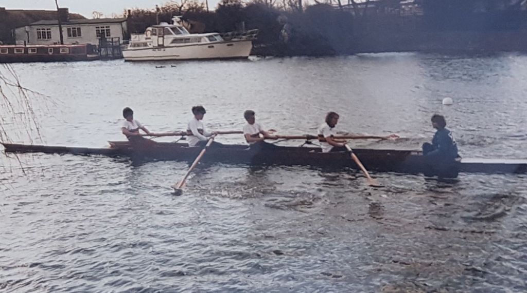 women's coxed four on river in winter