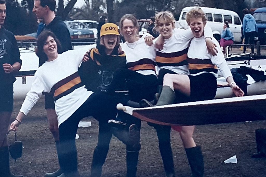 women and male coach with trophies and crossed blades