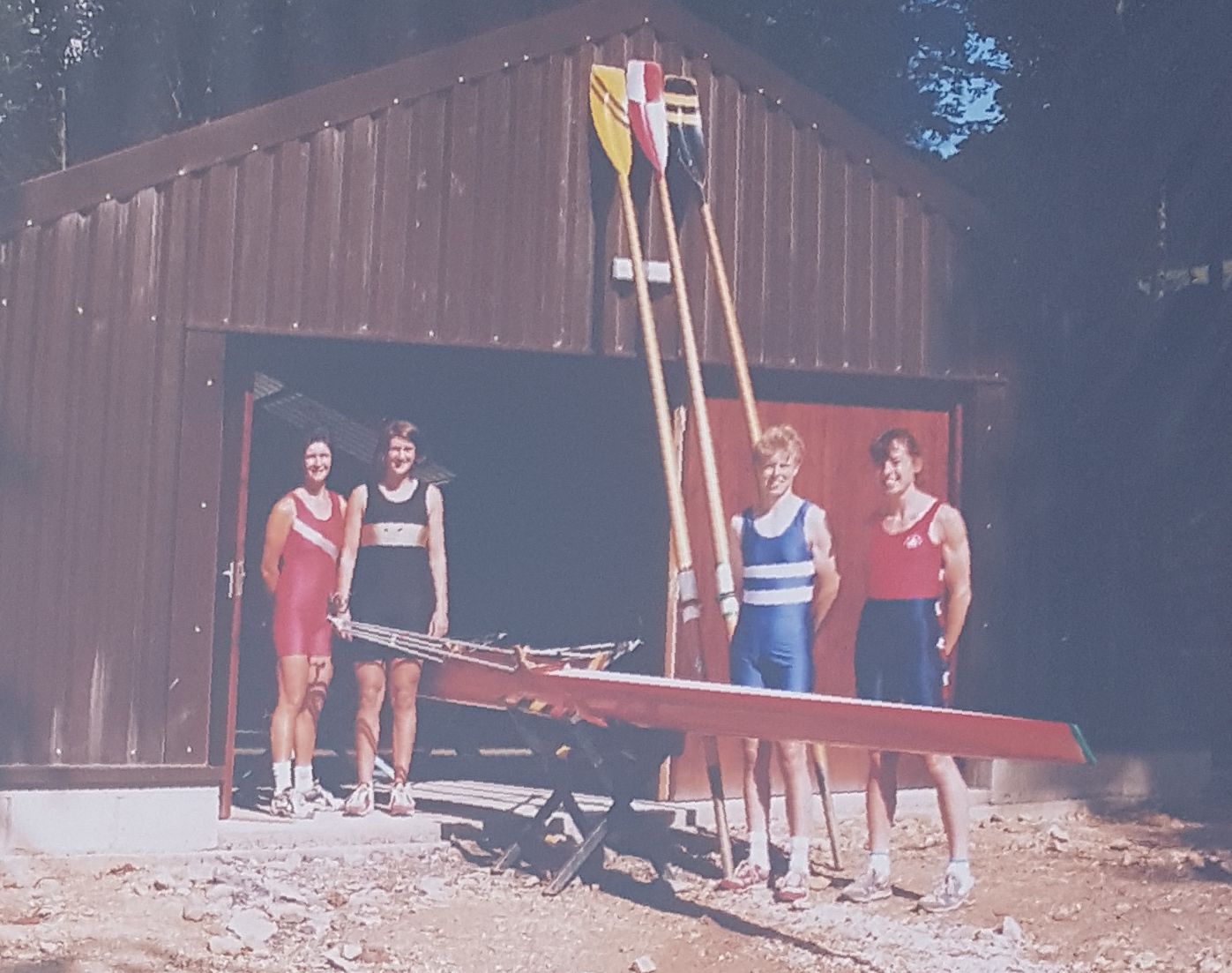 4 women standing by boat