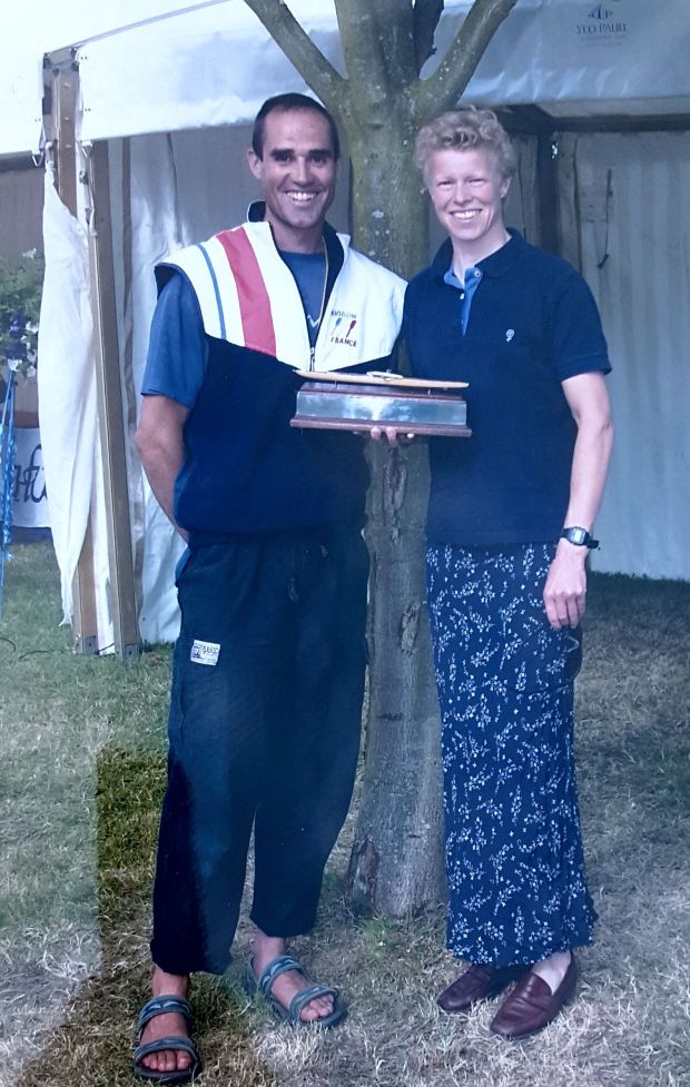 woman rower with male coach and trophy