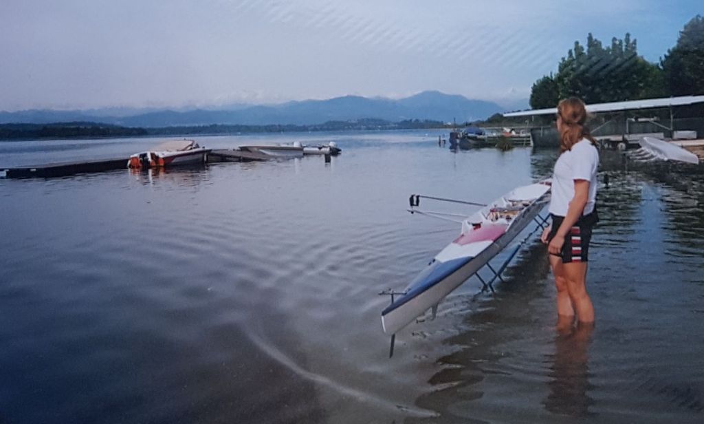 Woman standing in lake by rowing boat on trestles