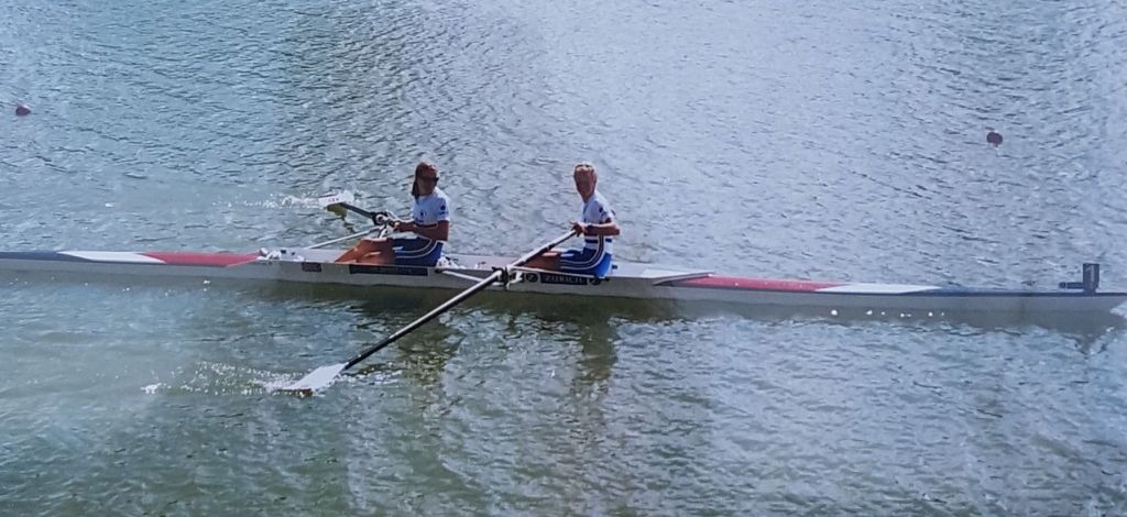 two women in pair with medals