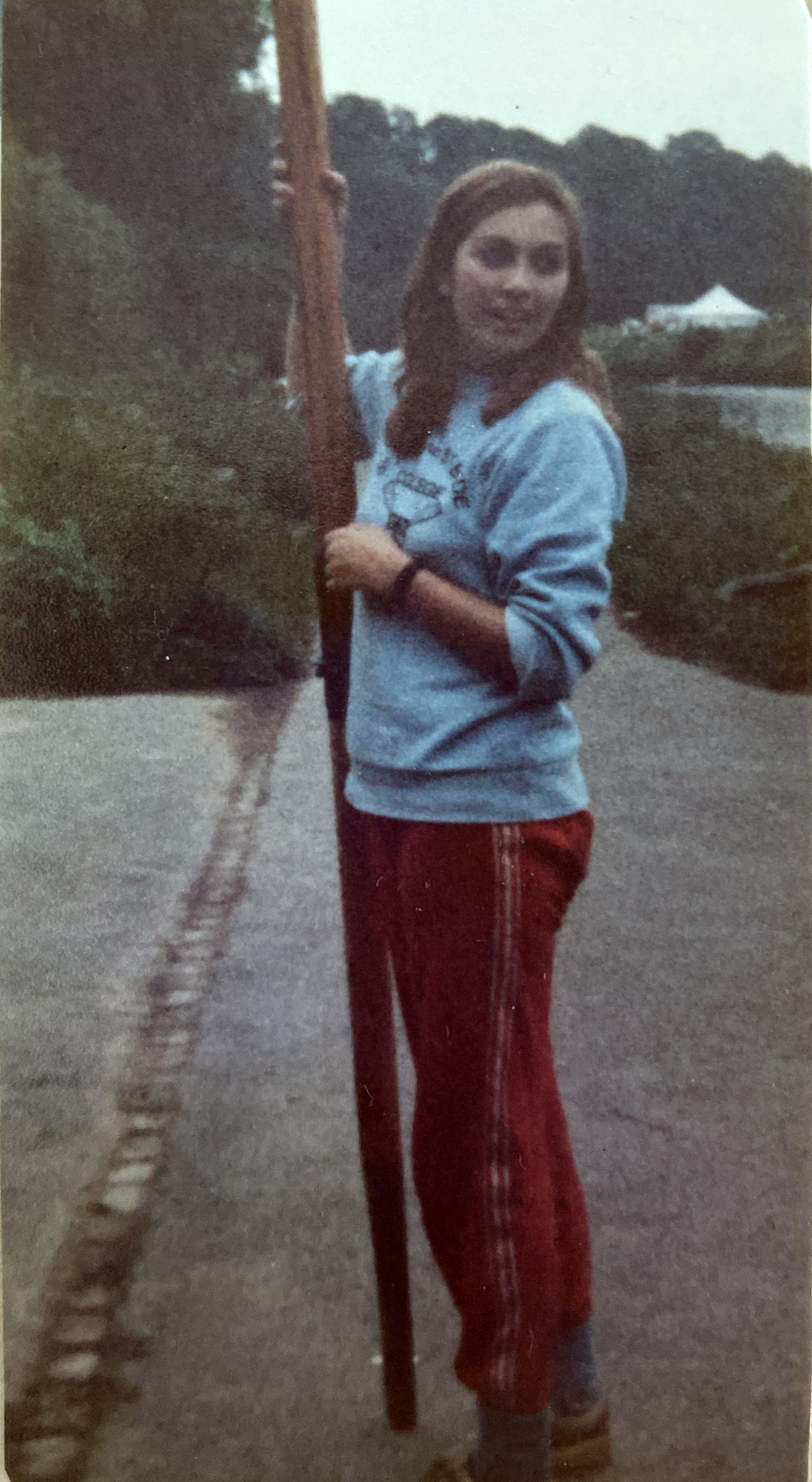 woman in blue sweatshirt holding oar