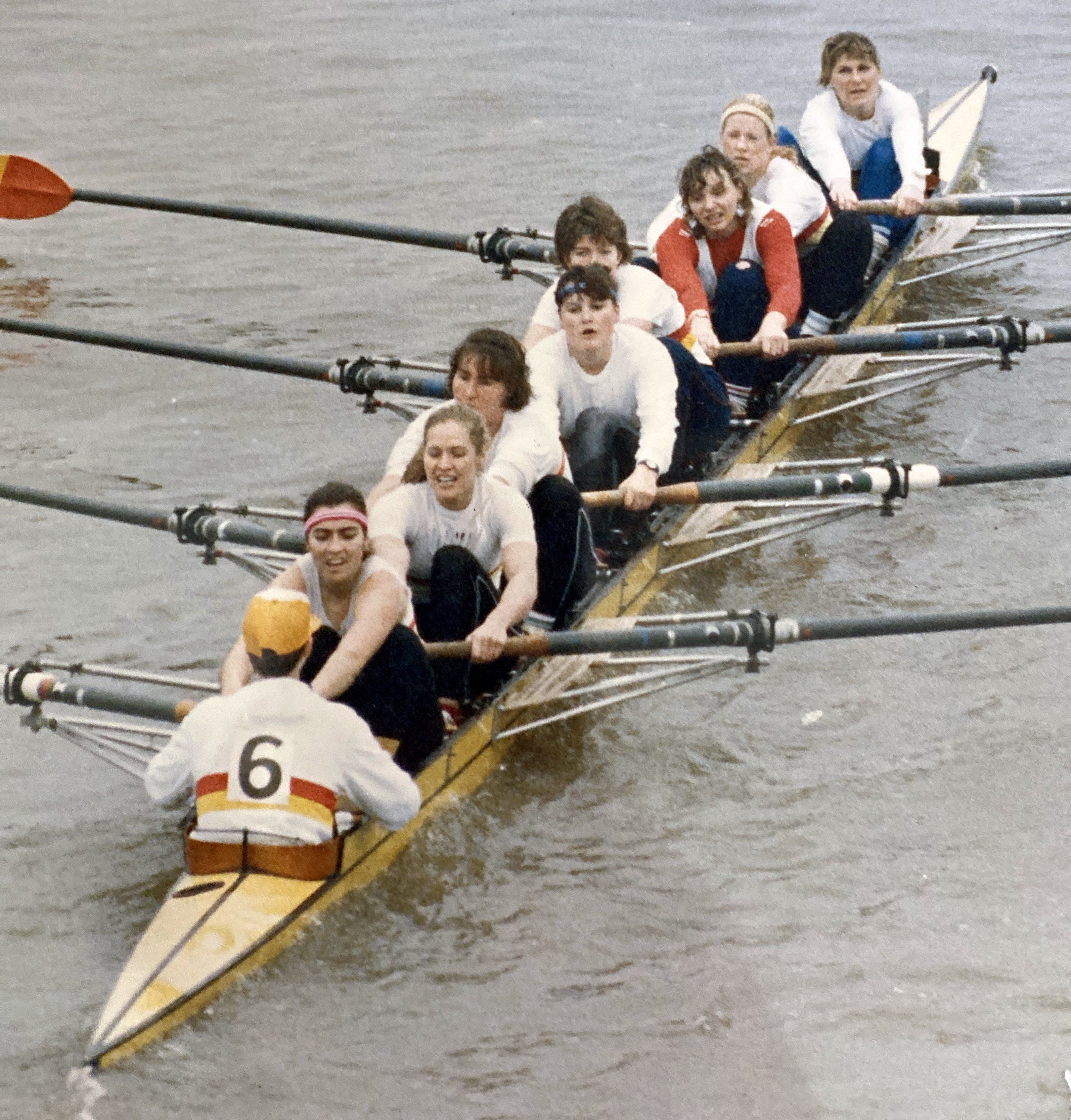Women's eight racing, cox wearing number 6.