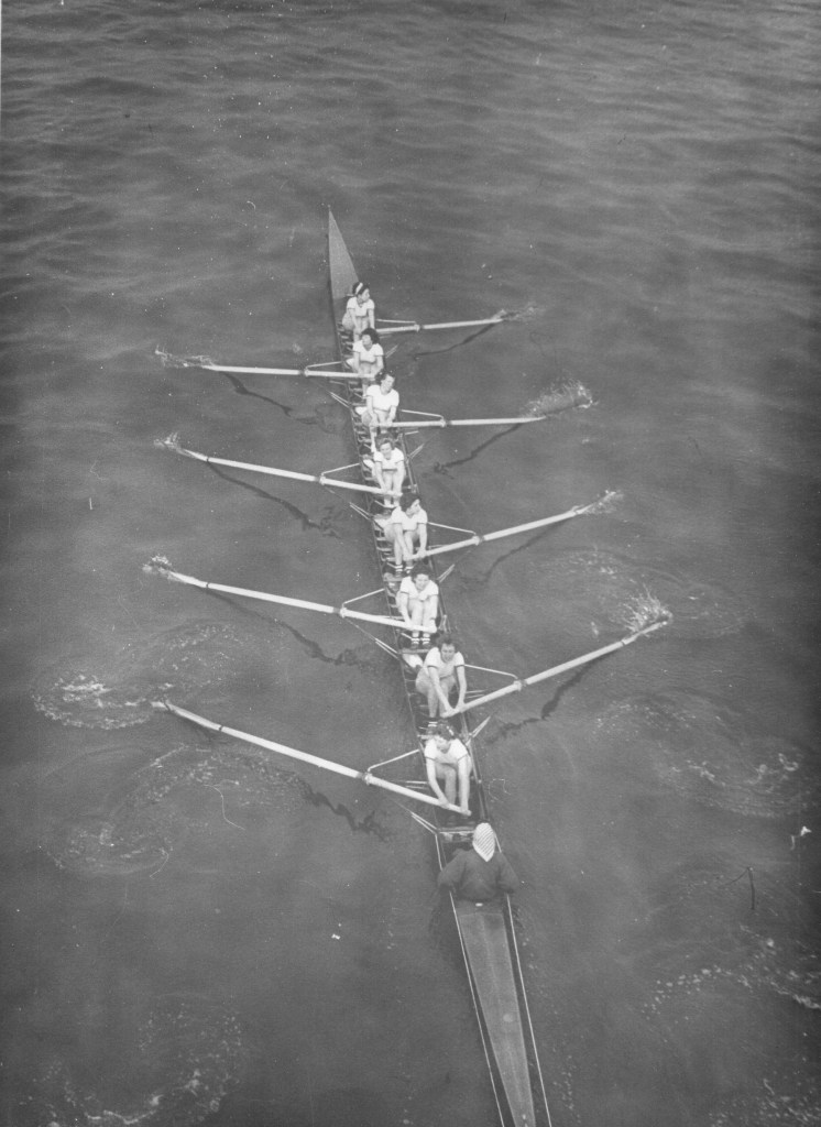 Women's eight racing, photographed from a bridge overhead