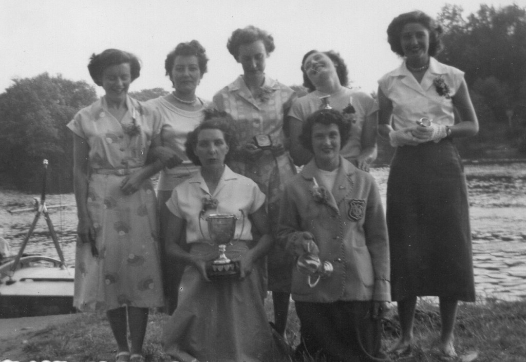 Formally-dressed women with trophies